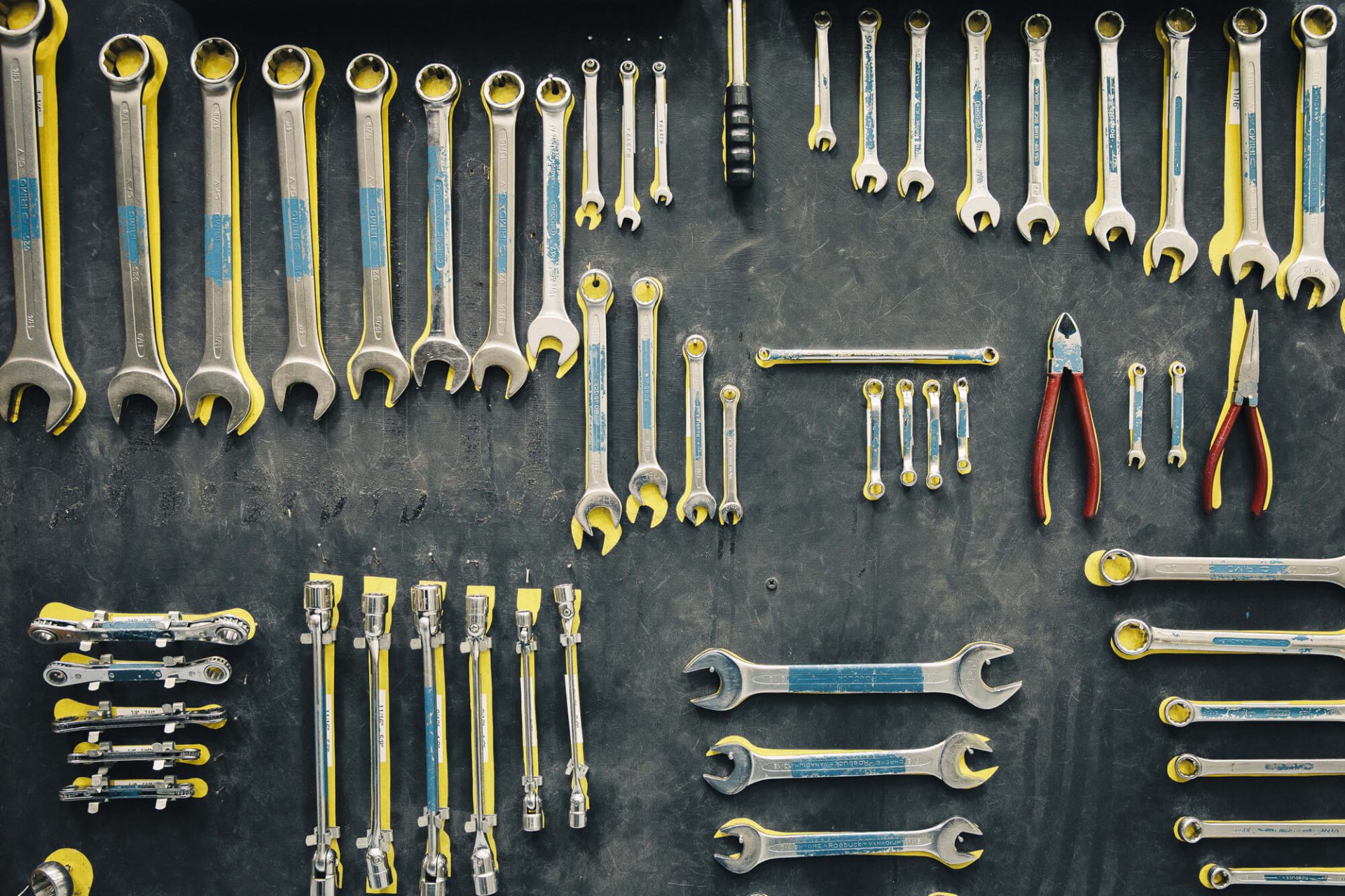 Wrenches and pliers hang up on a wall - tools for engineering courses in 