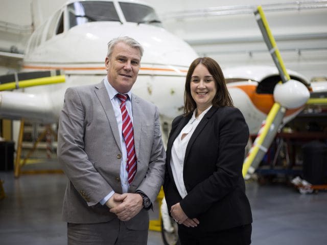 Richard Hyde, training leader, and Claire Thorogood, Director of Apprenticeships, at  standing infront of an airplane